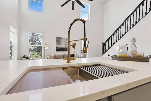 3907 Winding Path Dr, Canal Winchester, OH 43110 - kitchen with open floor plan, a towering ceiling, plenty of natural light, a ceiling fan, and a sink