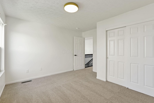 3907 Winding Path Dr, Canal Winchester, OH 43110 - unfurnished bedroom with carpet, baseboards, a closet, and a textured ceiling