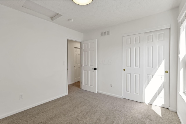3907 Winding Path Dr, Canal Winchester, OH 43110 - unfurnished bedroom with attic access, carpet flooring, a closet, baseboards, and a textured ceiling