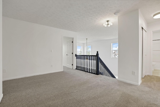 3907 Winding Path Dr, Canal Winchester, OH 43110 - unfurnished room featuring carpet, a chandelier, a textured ceiling, and baseboards