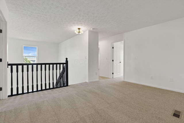 3907 Winding Path Dr, Canal Winchester, OH 43110 - spare room featuring carpet, baseboards, and a textured ceiling