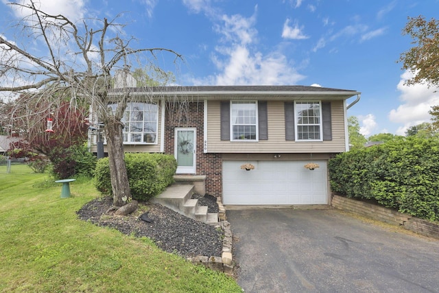230 Clover Ct, Newark, OH 43055 - split foyer home with asphalt driveway, a garage, a front yard, and brick siding