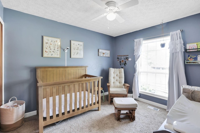 230 Clover Ct, Newark, OH 43055 - bedroom with multiple windows, a crib, carpet flooring, a textured ceiling, and baseboards