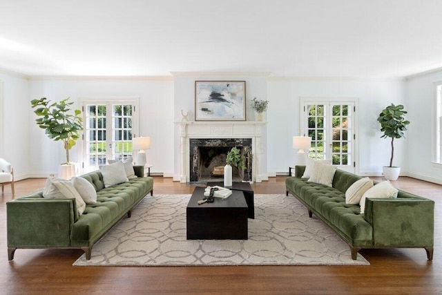 324 E N Broadway St, Columbus, OH 43214 - living area with healthy amount of natural light, ornamental molding, a fireplace, wood finished floors, and baseboards