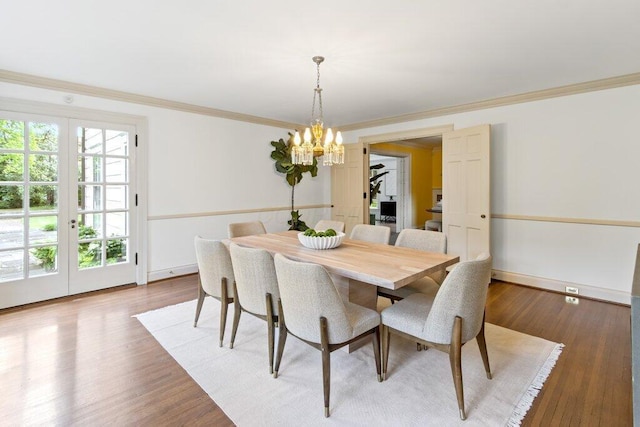 324 E N Broadway St, Columbus, OH 43214 - dining area with a chandelier, crown molding, wood finished floors, and baseboards