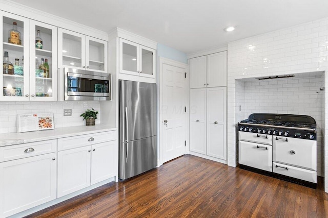 324 E N Broadway St, Columbus, OH 43214 - kitchen featuring stainless steel appliances, backsplash, light countertops, white cabinets, and dark wood-style flooring