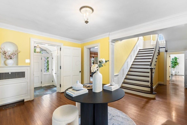 324 E N Broadway St, Columbus, OH 43214 - entrance foyer featuring wood finished floors, ornamental molding, and stairs