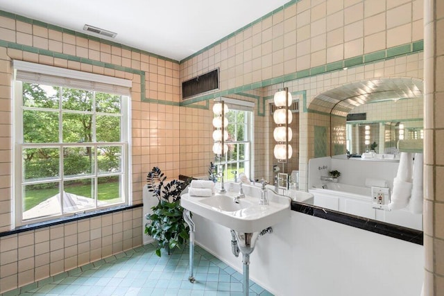 324 E N Broadway St, Columbus, OH 43214 - full bath with tile patterned flooring, tile walls, and a garden tub