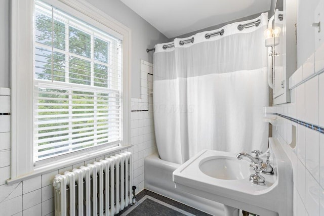 324 E N Broadway St, Columbus, OH 43214 - full bath with radiator heating unit, healthy amount of natural light, tile walls, and shower / tub combo