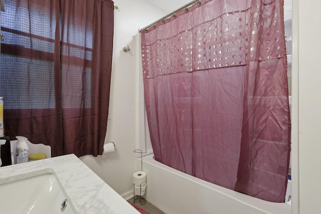 bathroom featuring shower / bath combination with curtain and a sink