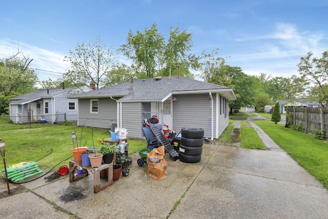 rear view of property with a patio area and a shingled roof