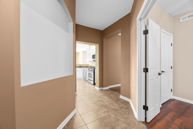 9032 Polaris Lakes Dr, Columbus, OH 43240 - hall with baseboards and light tile patterned flooring