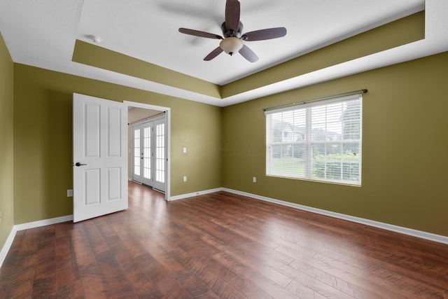 9032 Polaris Lakes Dr, Columbus, OH 43240 - empty room with ceiling fan, a raised ceiling, baseboards, and dark wood finished floors