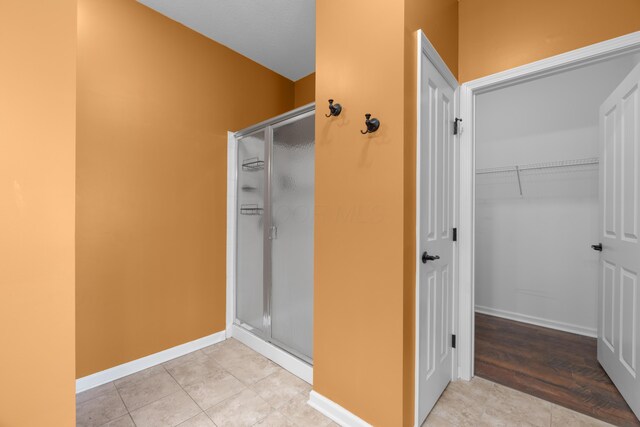 9032 Polaris Lakes Dr, Columbus, OH 43240 - full bathroom with a shower stall, tile patterned flooring, and baseboards