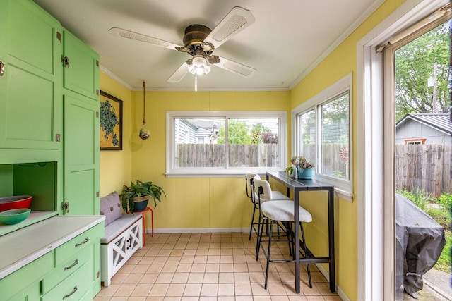 1674 Melrose Ave, Columbus, OH 43224 - dining space featuring baseboards, crown molding, a ceiling fan, and light tile patterned floors