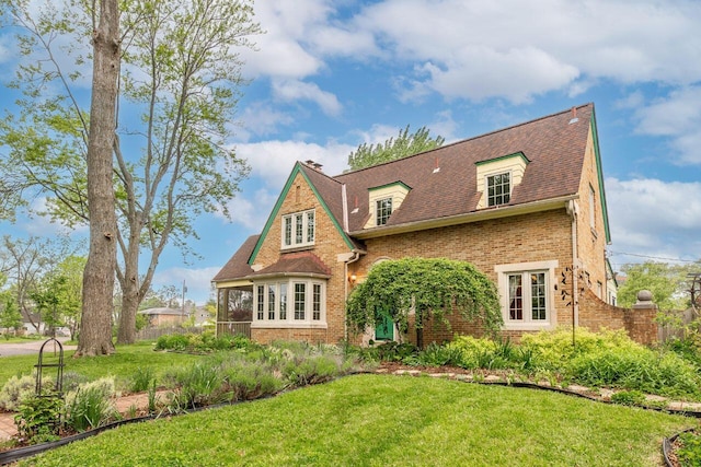 1674 Melrose Ave, Columbus, OH 43224 - view of front of house with brick siding, a front yard, and roof with shingles