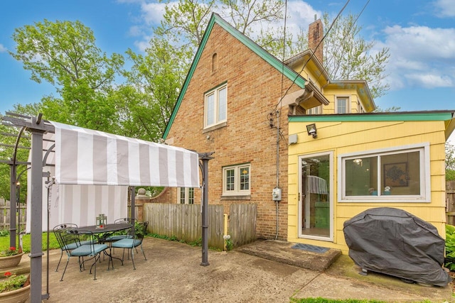 1674 Melrose Ave, Columbus, OH 43224 - back of property featuring fence, brick siding, a patio area, a pergola, and a chimney