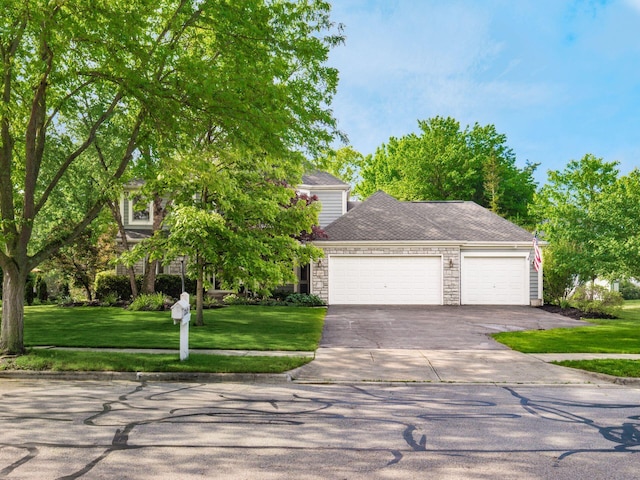 1249 Sea Shell Dr, Westerville, OH 43082 - view of front facade with an attached garage, concrete driveway, a front yard, and stone siding