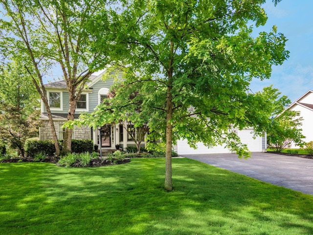 1249 Sea Shell Dr, Westerville, OH 43082 - obstructed view of property featuring stone siding, a front yard, and a garage