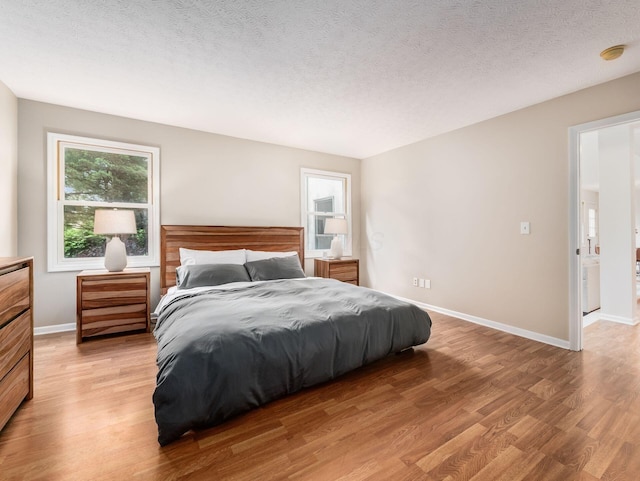 1249 Sea Shell Dr, Westerville, OH 43082 - bedroom with light wood-style floors, baseboards, and a textured ceiling