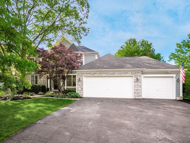 1249 Sea Shell Dr, Westerville, OH 43082 - view of front of house with driveway, a garage, a front yard, stone siding, and a shingled roof
