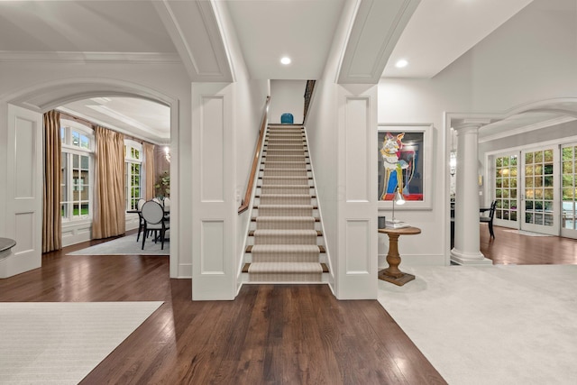2060 Fontenay Pl, Upper Arlington, OH 43220 - entryway with crown molding, dark wood-style floors, stairway, arched walkways, and ornate columns