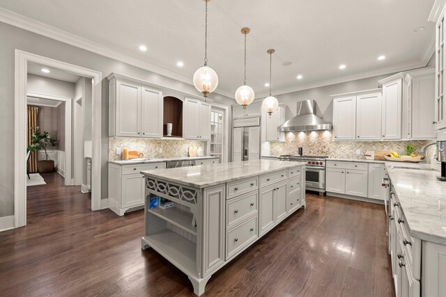 2060 Fontenay Pl, Upper Arlington, OH 43220 - kitchen featuring high quality appliances, wall chimney range hood, a sink, a kitchen island, and white cabinetry