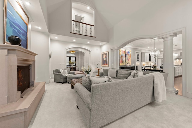 2060 Fontenay Pl, Upper Arlington, OH 43220 - living room featuring light colored carpet, decorative columns, arched walkways, a towering ceiling, and recessed lighting
