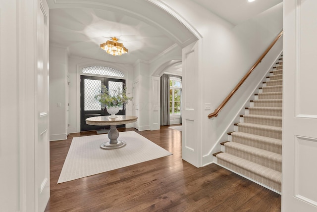2060 Fontenay Pl, Upper Arlington, OH 43220 - foyer featuring arched walkways, stairs, ornamental molding, dark wood-type flooring, and a chandelier