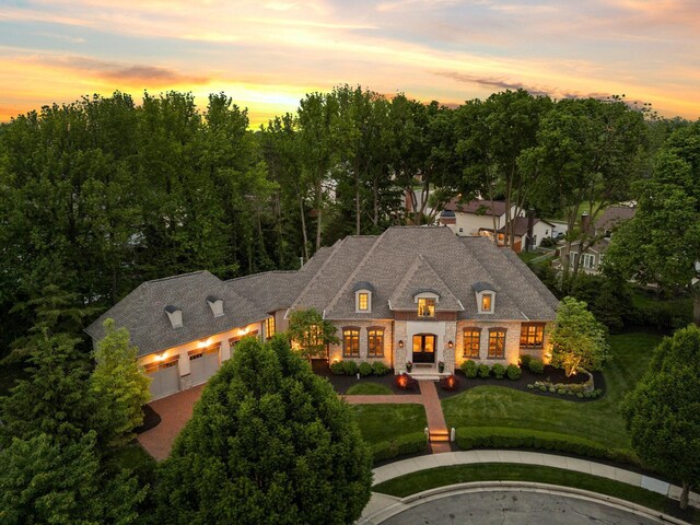 2060 Fontenay Pl, Upper Arlington, OH 43220 - french country style house with an attached garage, brick siding, driveway, and a front yard