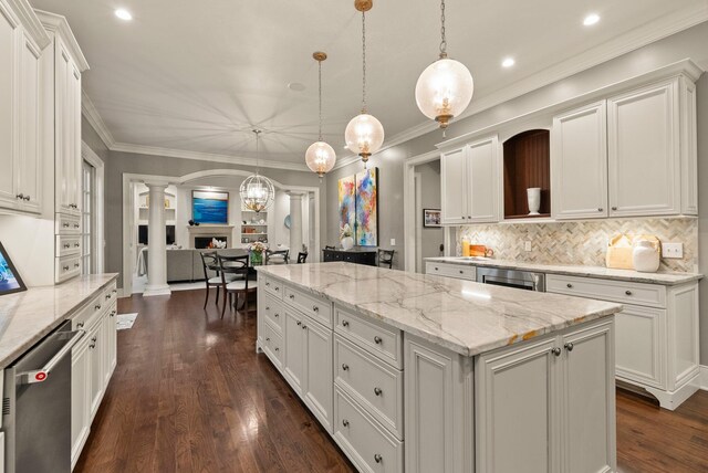 2060 Fontenay Pl, Upper Arlington, OH 43220 - kitchen with ornate columns, a center island, dishwasher, dark wood-type flooring, and white cabinets