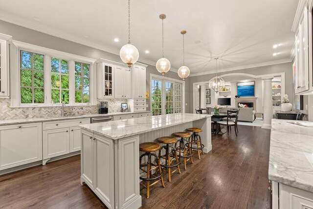2060 Fontenay Pl, Upper Arlington, OH 43220 - kitchen featuring ornate columns, white cabinetry, a kitchen island, decorative backsplash, and recessed lighting