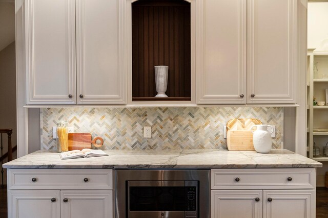 2060 Fontenay Pl, Upper Arlington, OH 43220 - kitchen featuring stainless steel microwave, white cabinets, decorative backsplash, and light stone counters