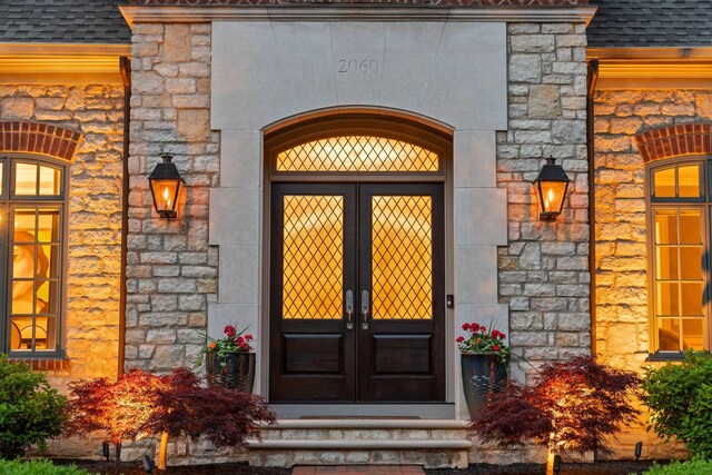 2060 Fontenay Pl, Upper Arlington, OH 43220 - property entrance featuring french doors, stone siding, and roof with shingles