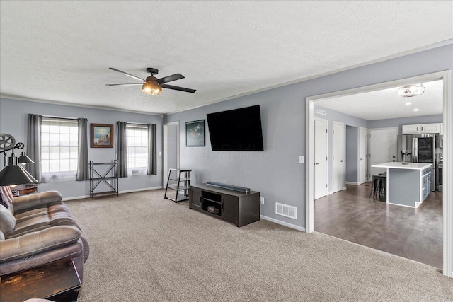 10746 State Route 287, Zanesfield, OH 43360 - living area with carpet floors, a textured ceiling, baseboards, and a ceiling fan