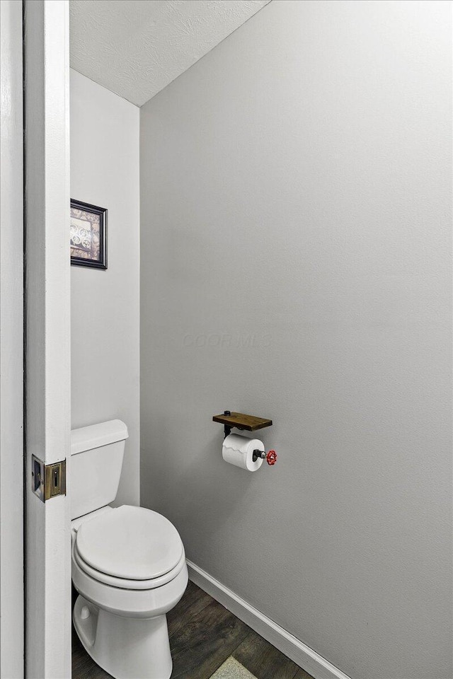 10746 State Route 287, Zanesfield, OH 43360 - bathroom with baseboards, toilet, wood finished floors, and a textured ceiling