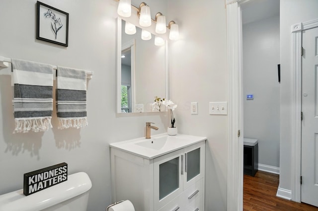 1077 Michigan Ave Unit 9, Columbus, OH 43201 - bathroom with vanity, toilet, wood finished floors, and baseboards
