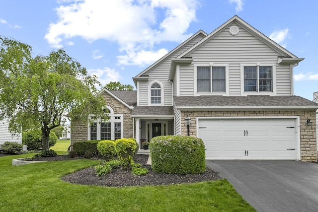 7257 Scioto Pkwy, Powell, OH 43065 - view of front of property with stone siding, asphalt driveway, an attached garage, and a front lawn