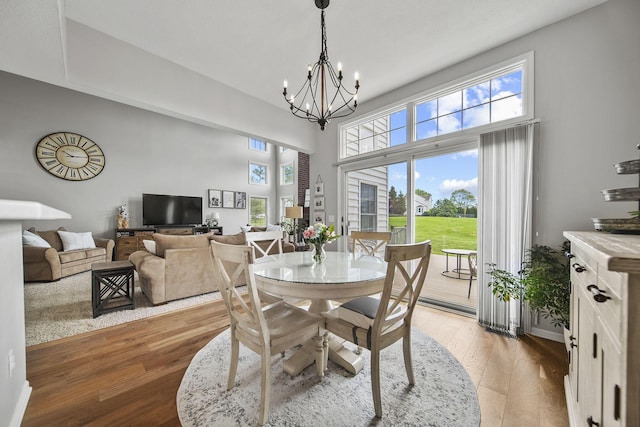 7257 Scioto Pkwy, Powell, OH 43065 - dining room featuring light wood-style floors, a chandelier, and a towering ceiling