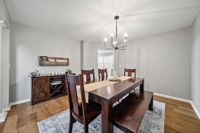 7257 Scioto Pkwy, Powell, OH 43065 - dining area featuring a chandelier, wood finished floors, and baseboards
