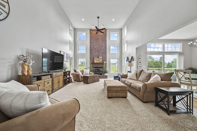 7257 Scioto Pkwy, Powell, OH 43065 - living room with a towering ceiling, a fireplace, recessed lighting, a chandelier, and ceiling fan