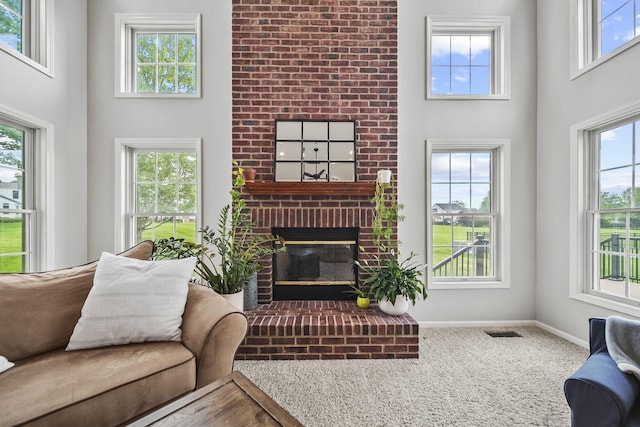 7257 Scioto Pkwy, Powell, OH 43065 - carpeted living area featuring a high ceiling, a brick fireplace, baseboards, and healthy amount of natural light
