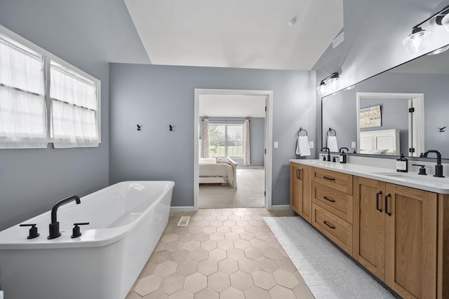 7257 Scioto Pkwy, Powell, OH 43065 - bathroom with tile patterned flooring, double vanity, ensuite bathroom, a freestanding tub, and baseboards