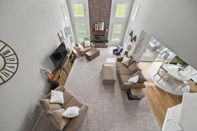 7257 Scioto Pkwy, Powell, OH 43065 - living area with a brick fireplace, a high ceiling, and wood finished floors