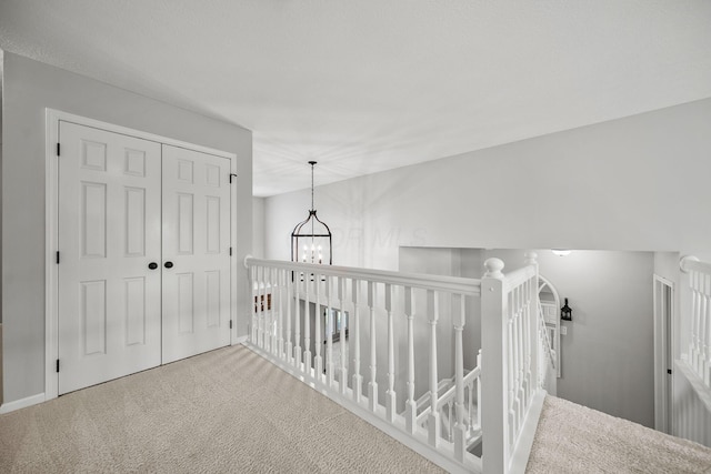 7257 Scioto Pkwy, Powell, OH 43065 - corridor with carpet floors, an upstairs landing, and a chandelier