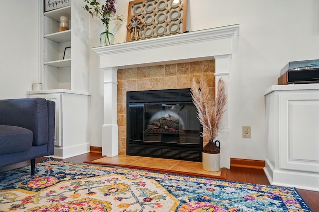 1407 Valley Dr, Marysville, OH 43040 - detailed view of wood finished floors, baseboards, and a tile fireplace