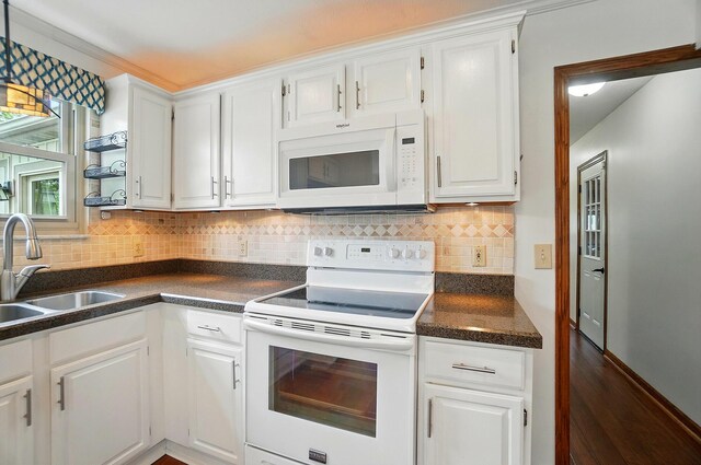 1407 Valley Dr, Marysville, OH 43040 - kitchen with white appliances, a sink, dark countertops, and white cabinetry