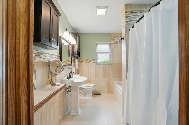 1407 Valley Dr, Marysville, OH 43040 - bathroom featuring a sink, tile walls, tile patterned flooring, toilet, and wainscoting