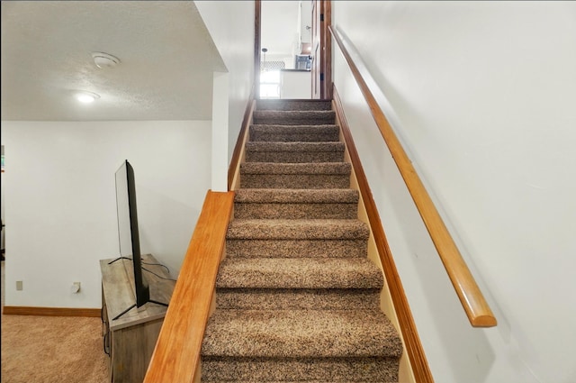 1407 Valley Dr, Marysville, OH 43040 - stairway featuring carpet flooring, a textured ceiling, and baseboards