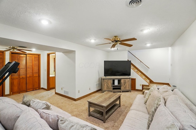 1407 Valley Dr, Marysville, OH 43040 - living area featuring ceiling fan, a textured ceiling, stairway, baseboards, and light carpet